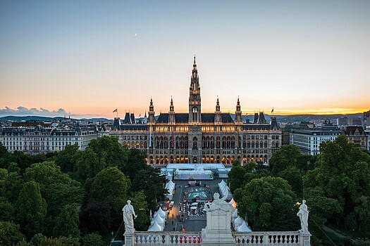 A frontal photo of Vienna's city hall at sunset, taken from the roof of the Burgtheater across the street. 